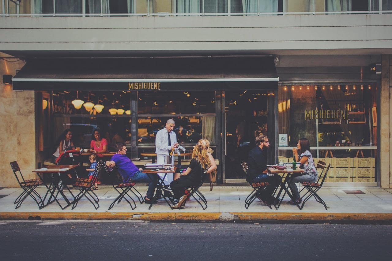 customer engagement view: a waiter at the restaurant serving his customers