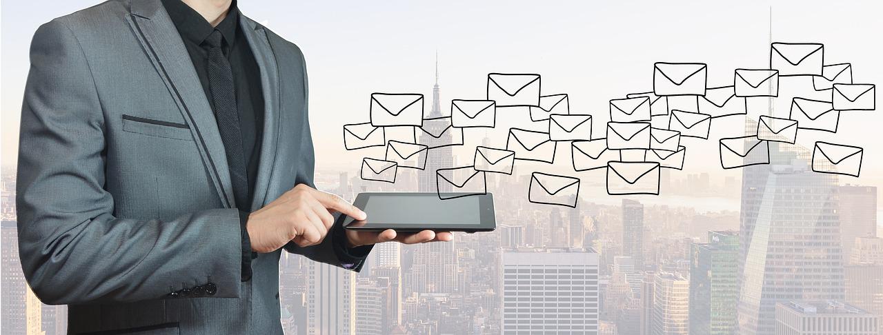 a man typing emails to contact