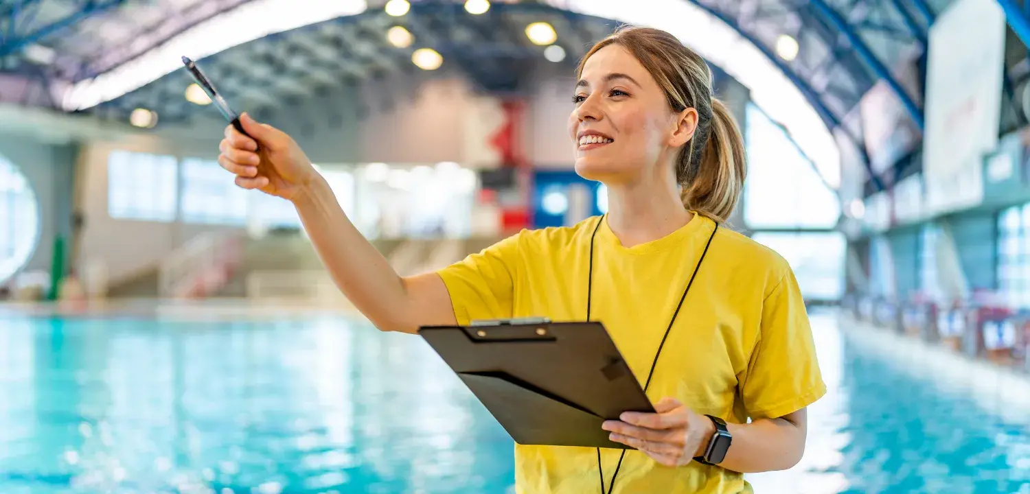a woman acting as a lifeguard trainer, giving lifeguard courses overview
